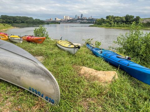 Kansas City, KS - July 31, 2023: Kayak and canoes at Kaw Point Park, confluence of the Missouri and Kansas Rivers, with a cityscape of Kansas City, MO.