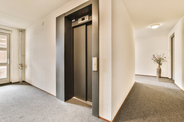 an empty room with two doors and a plant in the middle one door is open to let you into it