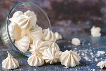 Small white meringues on a colored background