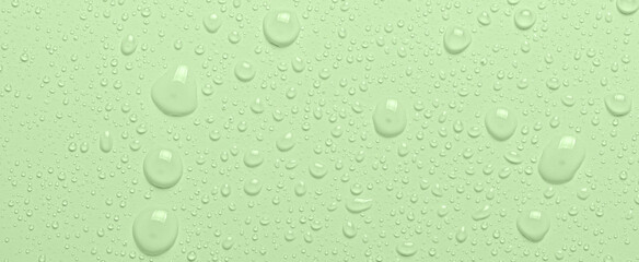 Drops of micellar water or cosmetic tonic on a green background. Close-up, macro photography
