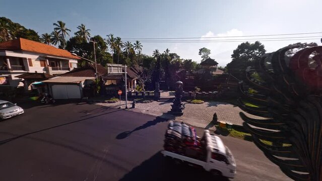 Garuda Visnu statue at Bali, Indonesia. FPV Drone flight around it and near local temple complex. Not far from Besakih town. Black volcanic rock with detailed golden features craftmanship