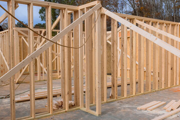 New house is under construction with wooden framework where support beams are being built to support