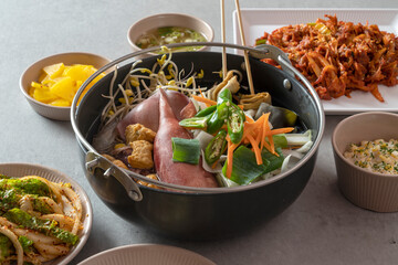 Korean food dish Stir-fried cartilage rice ball, seafood fish cake soup, boiled pork, tofu, kimchi, and stir-fried pork
