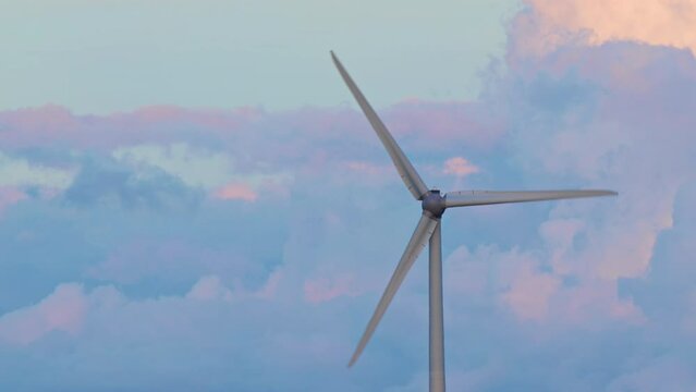 Wind turbine rotating clouds in the background