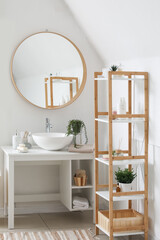 Fototapeta na wymiar Interior of bathroom with sink bowl, bath accessories, mirror and shelving unit