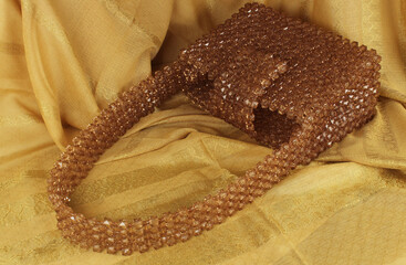 Handmade mink bead bag on cream fabric.