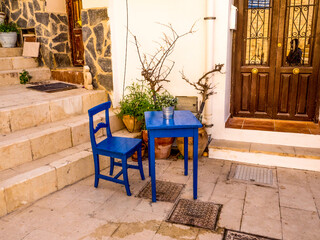 Blue painted wooden chair and small table on patio in spain