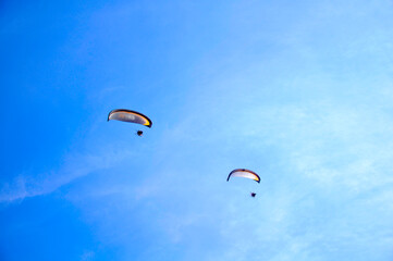 Paragliding in the blue sky.