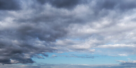 Cloudy pre-stormy sky as a background. Dramatic heaven.