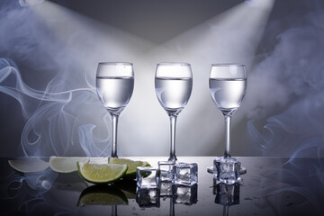 glasses with vodka with lime on the background of night club
