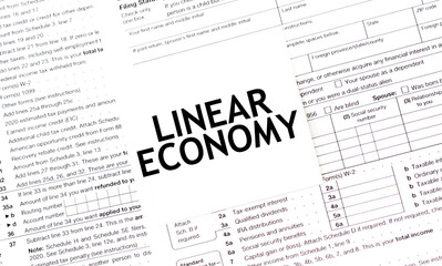 LINEAR ECONOMY words on paper sheet with documents