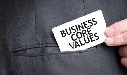 Card with BUSINESS CORE VALUES, text in pocket of businessman suit. Investment and decisions business concept.