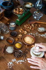 Herbs, seeds, salt and spices in wooden spoons and bowls on wooden table. Set of spices and herbs for cooking. Small bowls with colorful seasonings and spices