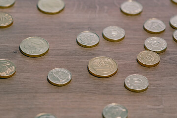 Many euro coins random pattern on a wooden surface