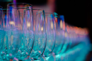 Many glasses of different wine in a row on bar counter