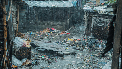 Plastic and garbage dump on land in slum during rainfall