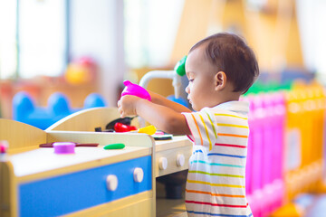 Cute baby boy in kindergarten or daycare.