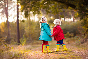 Kids play in autumn park. Children in fall.