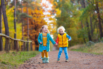 Kids play in autumn park. Children in fall.