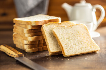 White sliced toast bread on wooden table.