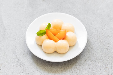 Apricot cream dessert, Panna Cotta in the shape of truffles, decorated with fresh apricot slices. Top view