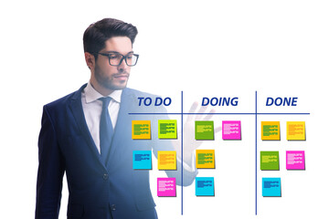 Businessman working on kanban board with tasks