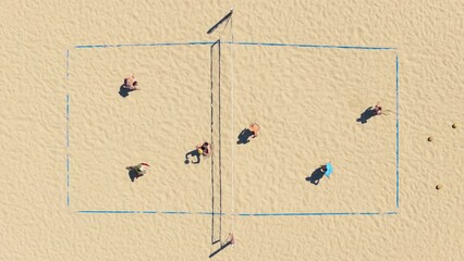 Top view of people playing volleyball on the beach of Santa Monica, Los Angeles, California, USA. Overhead shot of athletes taking part in beach volleyball competition. Healthy concept, 4k footage 