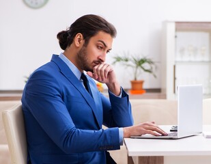 Young male employee in self-quarantine concept