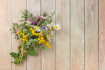 Floral arrangement of wild herbs and flowers , autumn background, Bouquet of tansy, mint, celandine, chamomile and yarrow, collection of useful herbs for treatment according to folk recipes.