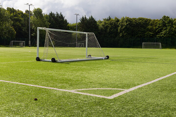 A empty goal posts in a empty football pitch 