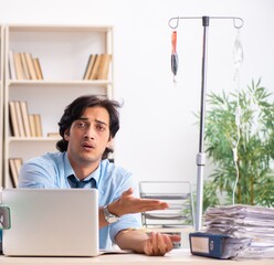 Young male employee in blood transfusion concept