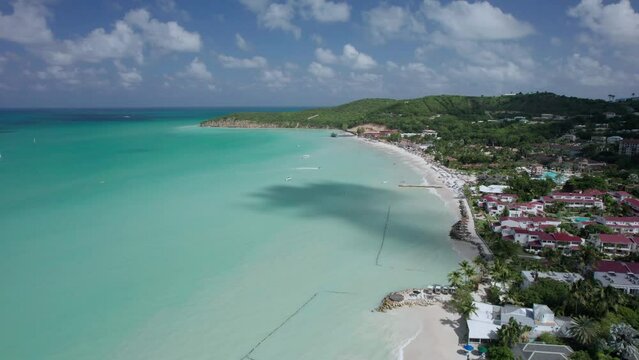 The drone aerial footage of Dickenson Bay beach, Antigua Island. Dickenson Bay is on the Northwestern coast of Antigua and is the most developed beach on the island.