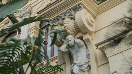 Sculpture of man on patterns wall of old building