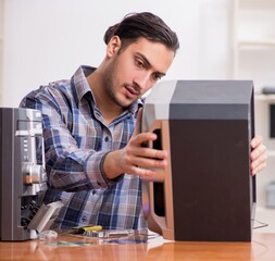 Young engineer repairing musical hi-fi system