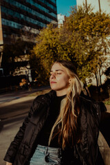 portrait of latin woman sitting enjoying the sun on her face in a city in argentina