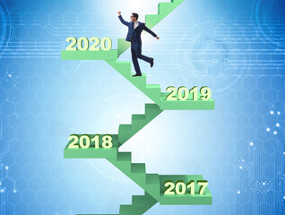 Businessman climbing stairs on yearly basis