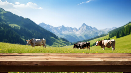 .Empty wooden tabletop for background and product montage, Adipian meadow with a herd of cows, natural dairy product banner and advertisement mockup with beautiful mountains alpine meadow behind