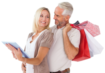 Digital png photo of caucasian couple with tablet and shopping bags on transparent background