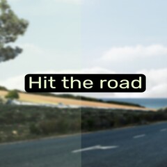 Composite of hit the road text over road and landscape