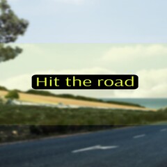 Composite of hit the road text over road and landscape