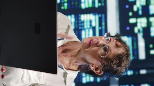 Vertical video Older colleagues looking around innovative server farm, preparing to start comission on malfunctioning high tech establishment hardware rows in order to ensure perfect operations