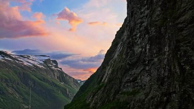 Dramatic and picturesque sunset along the steep mountain fjords of Geiranger, Norway