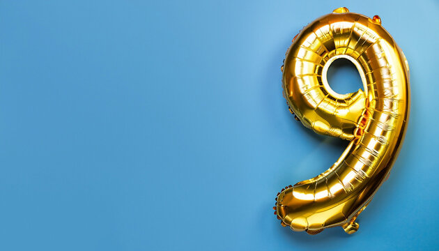 Banner with number 9 golden balloon with copy space. Nine years anniversary celebration concept on a blue background.