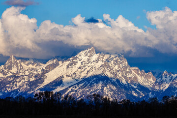 Landscape of the snow covered Teton Mountain range with heavy cloud cover in Grand Teton National Park, Wyoming, USA  
