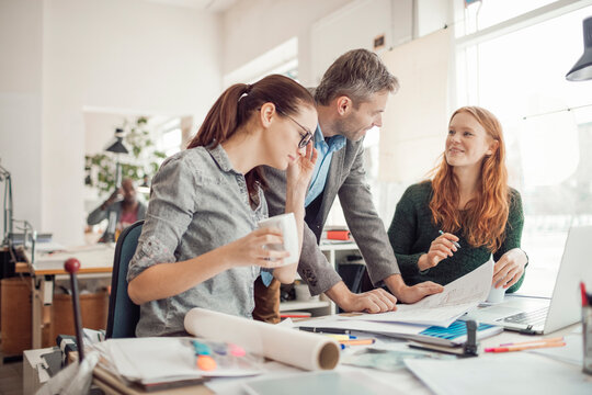 Group of people working together on a project in a startup company office