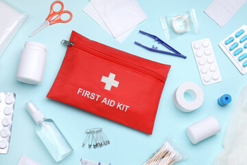 Flat lay composition with first aid kit on light blue background