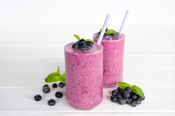 Blueberry Juice smoothies drink in a glass drink purple colorful fruit juice milkshake blend beverage healthy high protein the taste yummy in glass on white wood background.