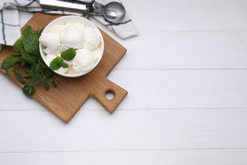 Fototapeta na wymiar Delicious vanilla ice cream, mint and scoop on white wooden table, flat lay. Space for text
