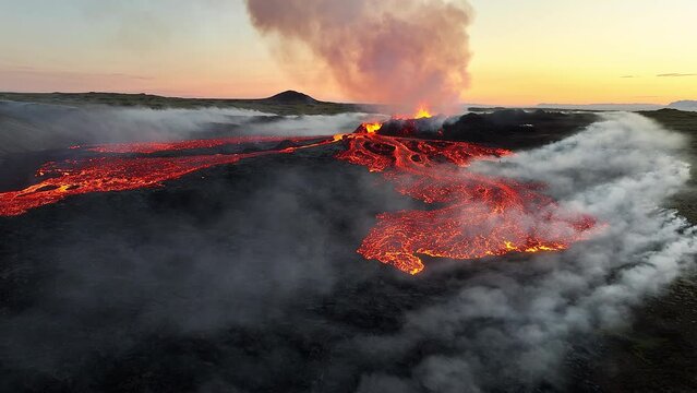 Volcano eruption, red hot burning lava erupts from ground, drone fly over active volcanic crater. Litli Hrutur Eruption 2023, Iceland.