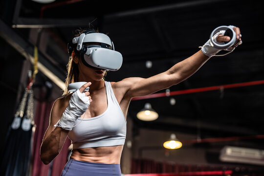 Asian sportswoman using innovative technology VR glasses for exercise.  - Powered by Adobe